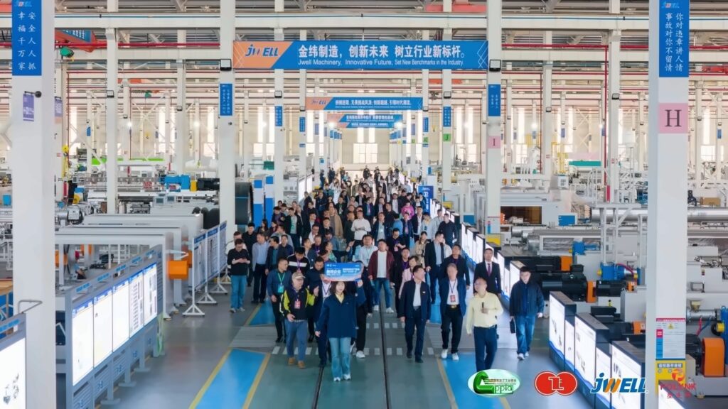 Delegates walking down a factory aisle during a visit to JWELL manufacturing facilities