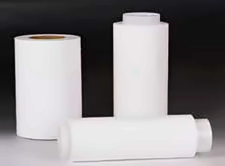 Three white film rolls on a dark gradient background